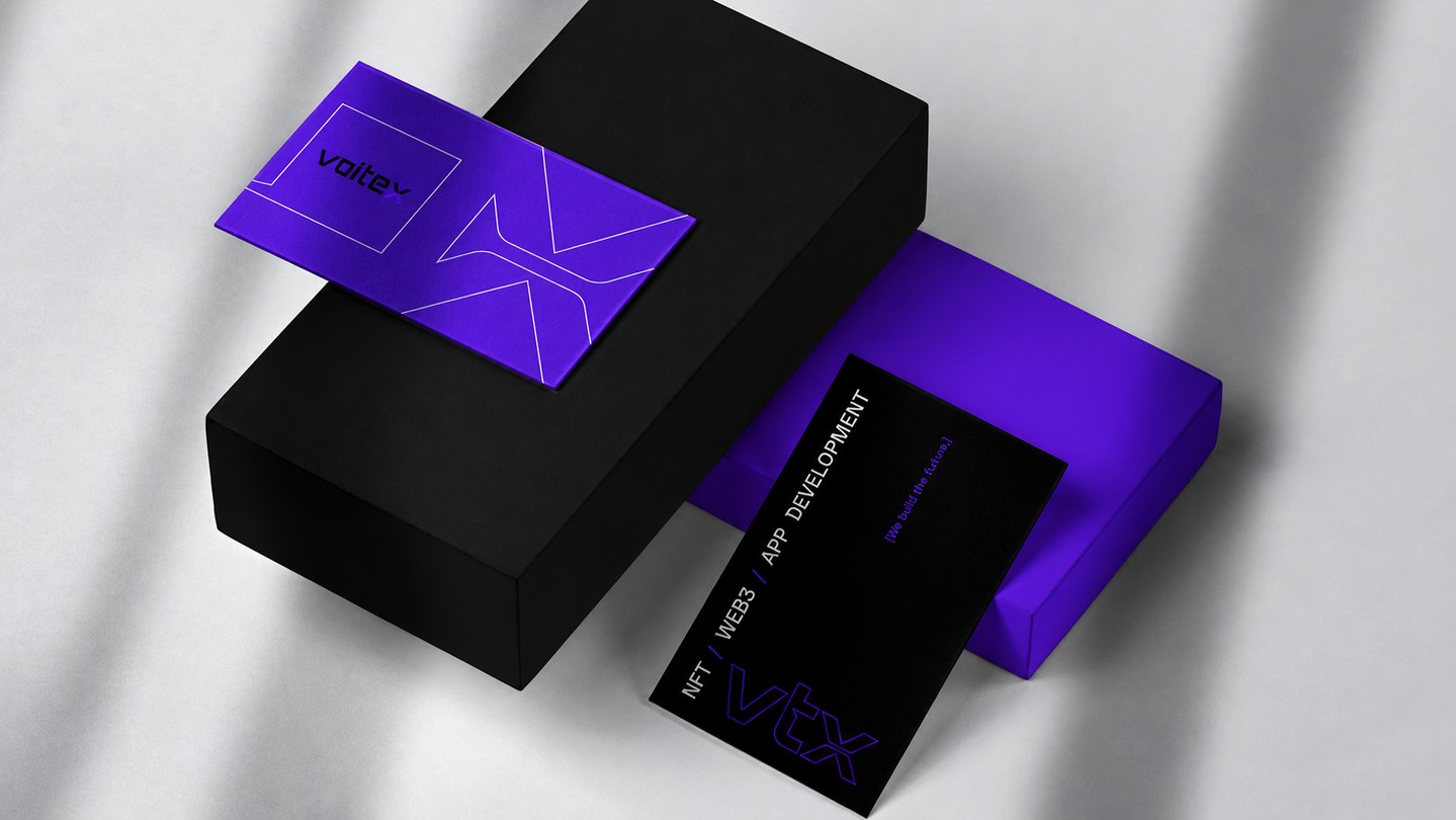 Voitex stationery and packaging mockup — purple and black business cards resting on branded boxes